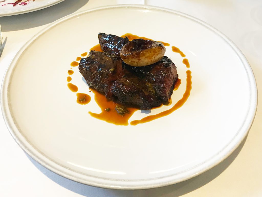 Grilled Hanger Steak, Braised Onion, Peppercorn Sauce